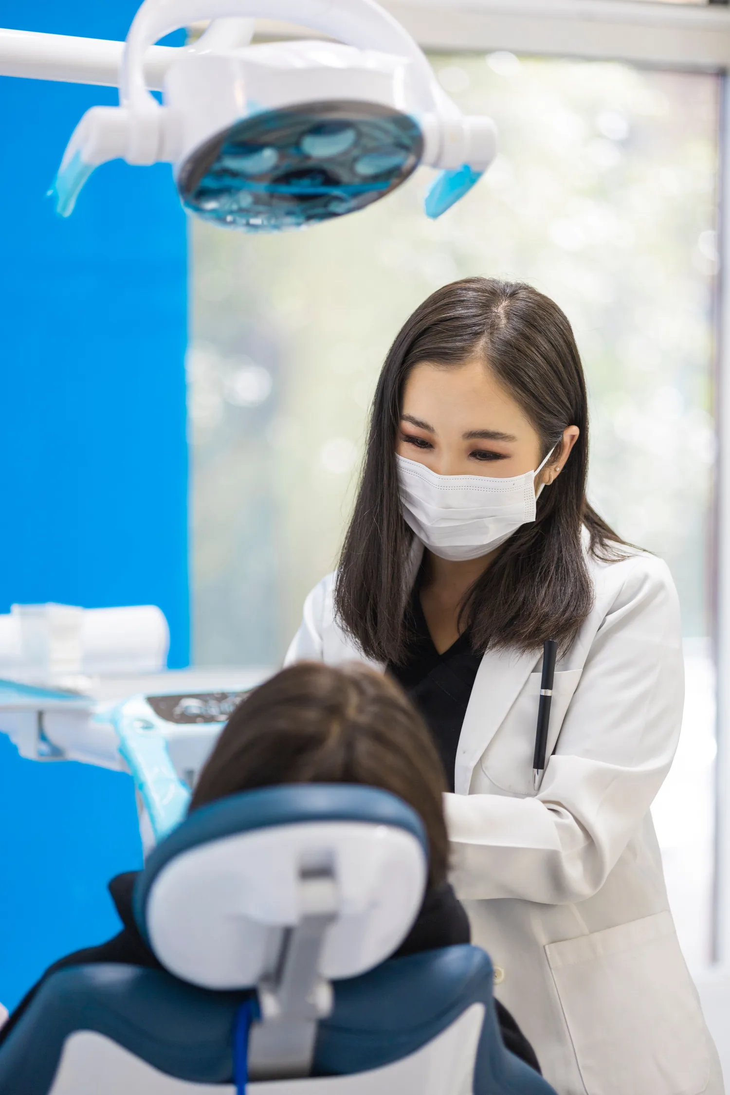 Illustrative dentist providing care in a bright clinic