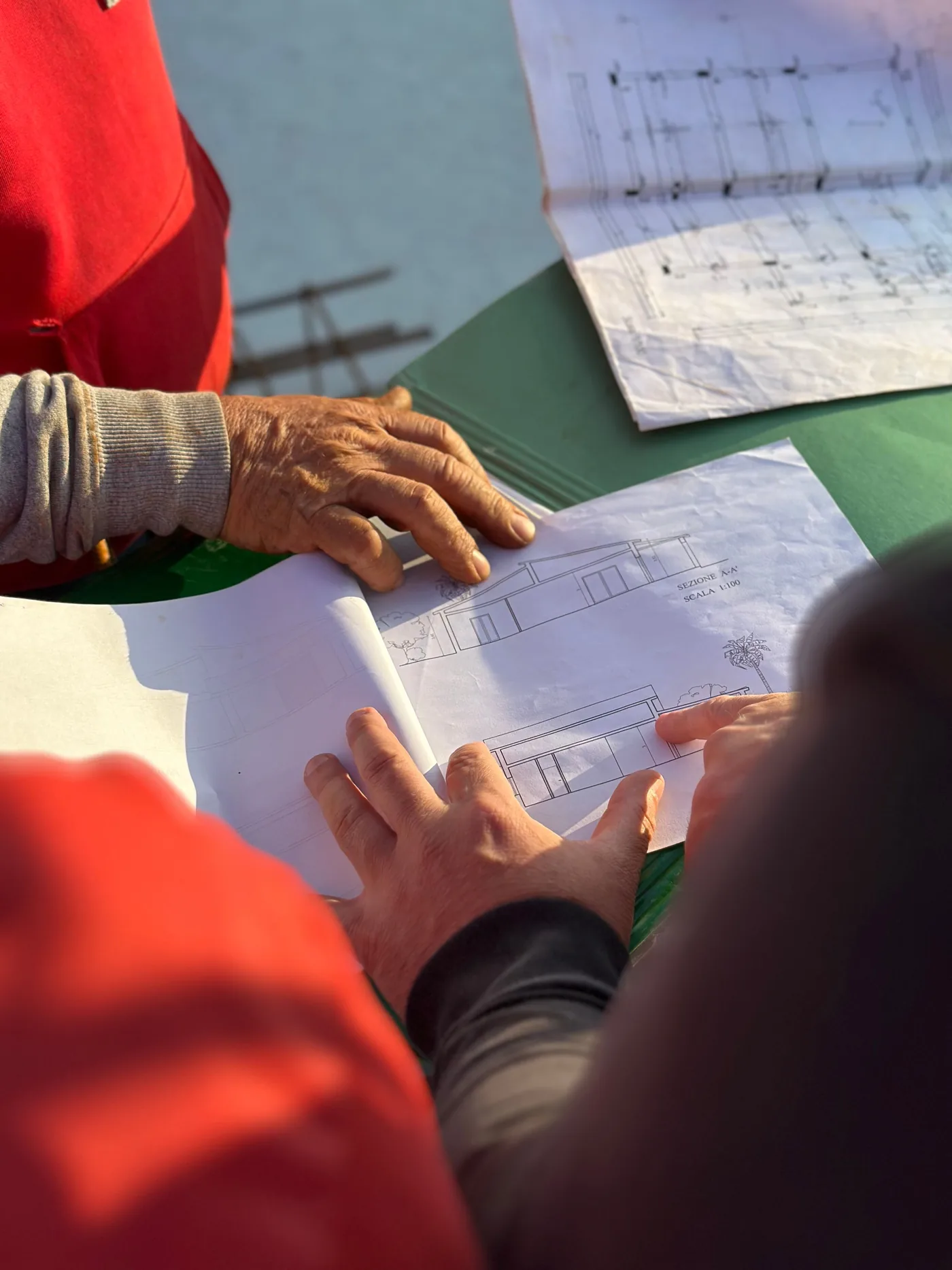 Illustrative construction team reviewing architectural drawings